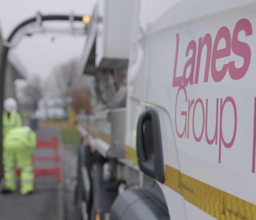 White Lanes Group truck alongside drainage engineers in high-visibility clothing and roadworks